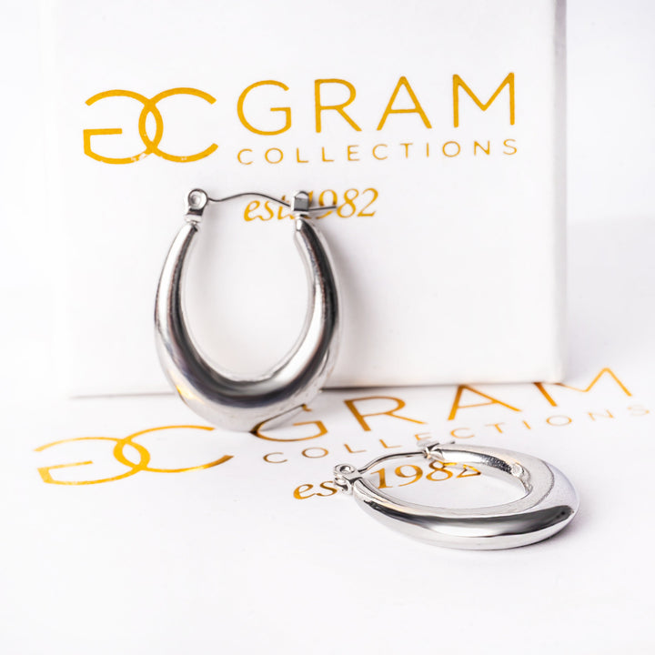 A close up view Sandra Silver Earrings standing placed on its message. 