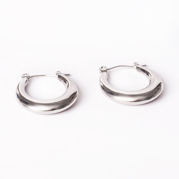 A close up view of Sandra Silver Earrings standing in the center of the image against a white background. 