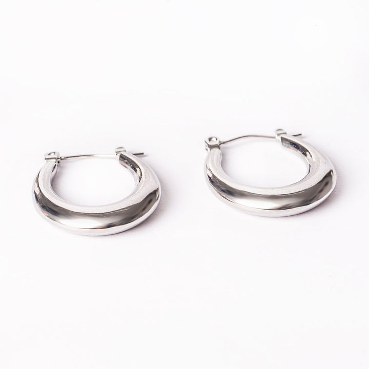 A close up view of Sandra Silver Earrings standing in the center of the image against a white background. 