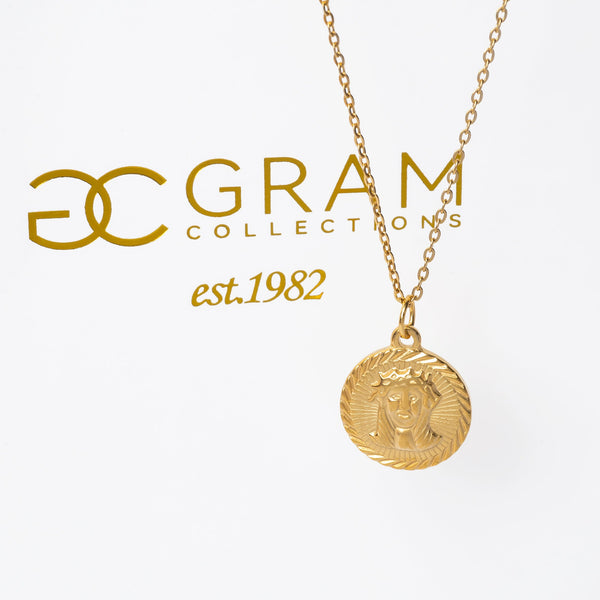 A gold-plated stainless steel  Saviour pendant necklace with a chain. The pendant features a relief of the savior and the necklace has a yellow gold color.