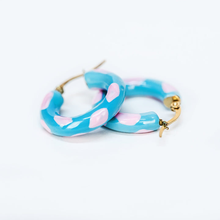 A close up view of sea earrings standing in the center of the image against a white background. 