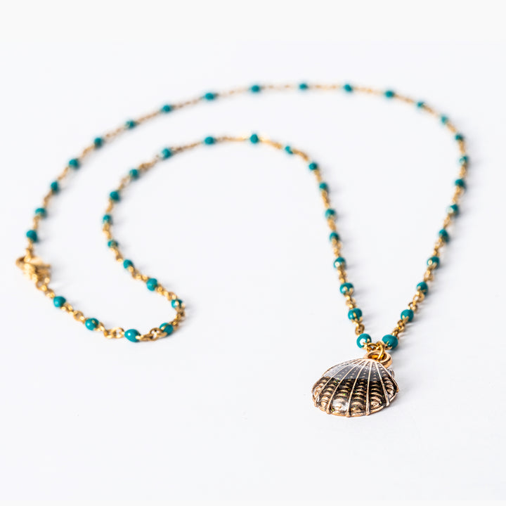 A close up view of Seashell Necklace placed on a white background. 
