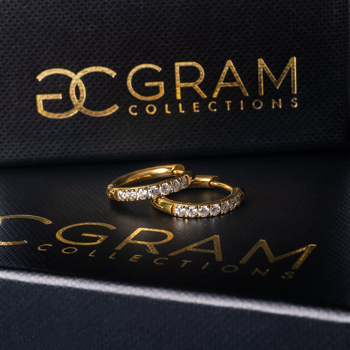 Sharm Gold Earrings standing on its uniquely designed black box. 