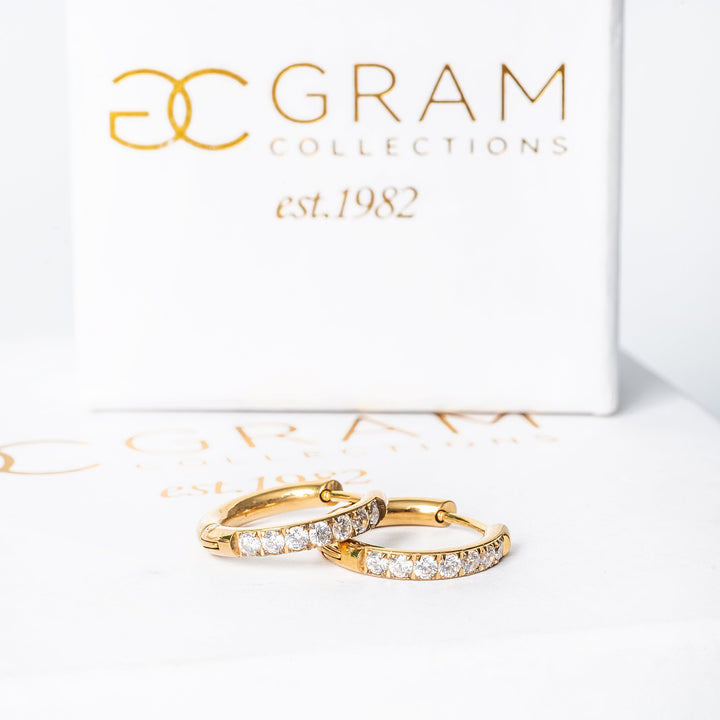 Sharm Gold Earrings placed on its beautifully designed gram collections box. 