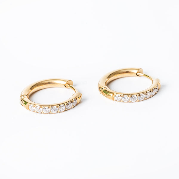 A close up view of Sharm Gold Earrings standing against a white background. 