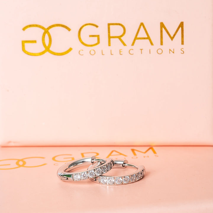 Sharm Silver Earrings placed on their gram collections box. 