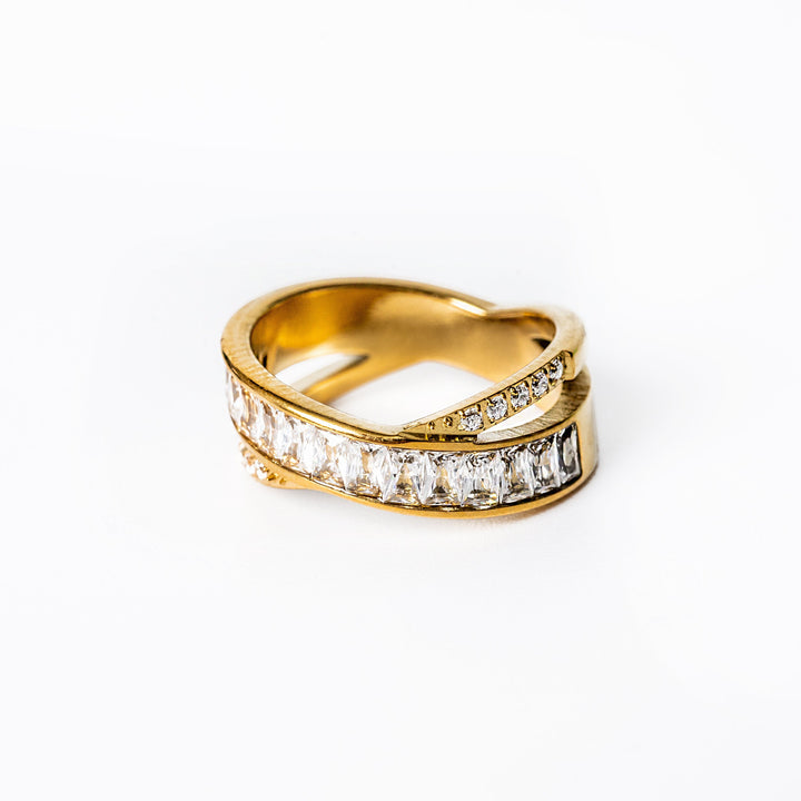 A close up view of Shelly Gold ring standing in the center of the image against a white background. 