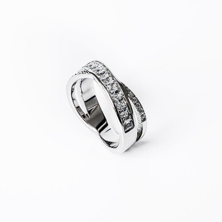 A close up view of Shelly Silver Ring standing in the center of the image against a white background 
