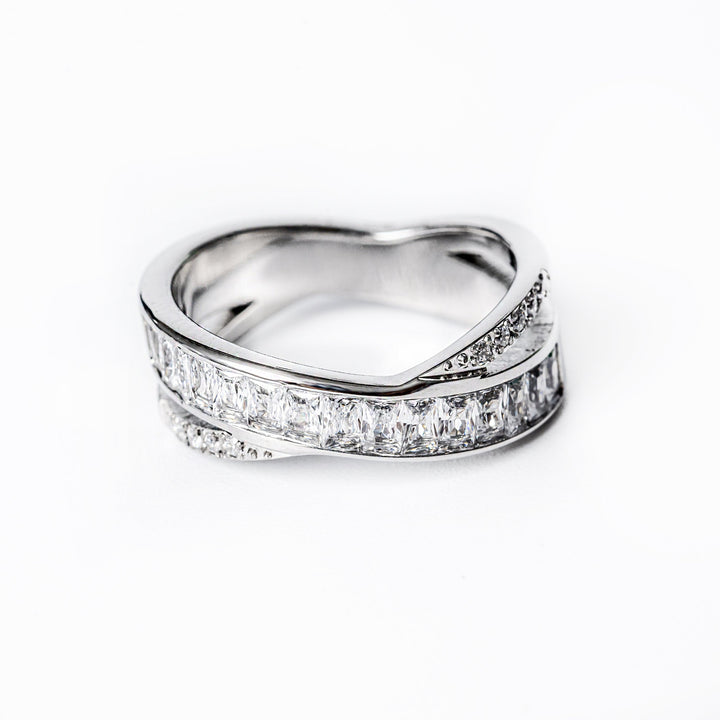A silver-colored stainless steel ring with a gold plating, featuring a split design with cubic zirconia embellishments.