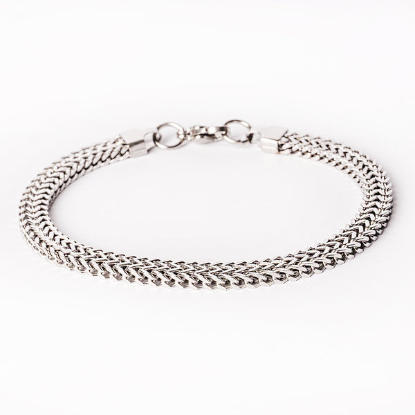 A silver stainless steel bracelet with a solid pattern and a clasp closure.
