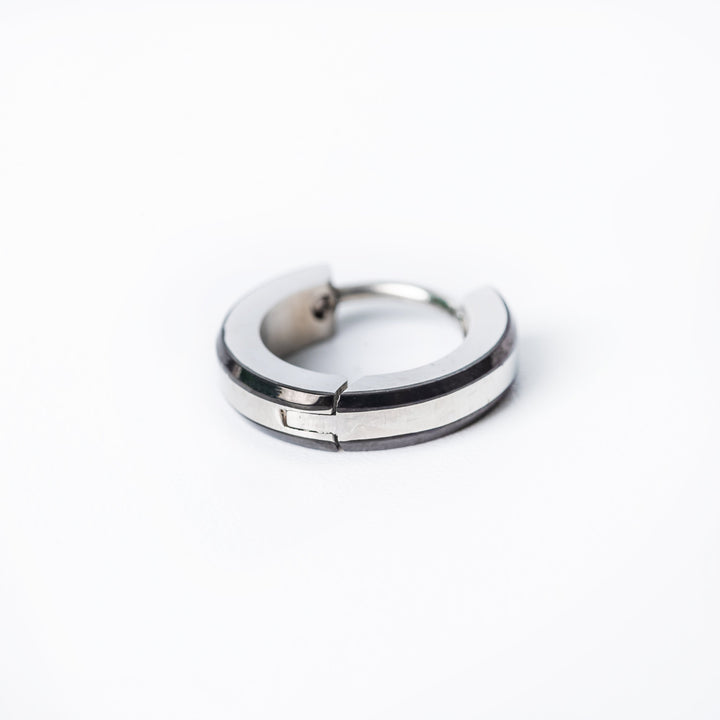 A single silver-colored Simon hoop earring made of stainless steel, displayed against a white background.