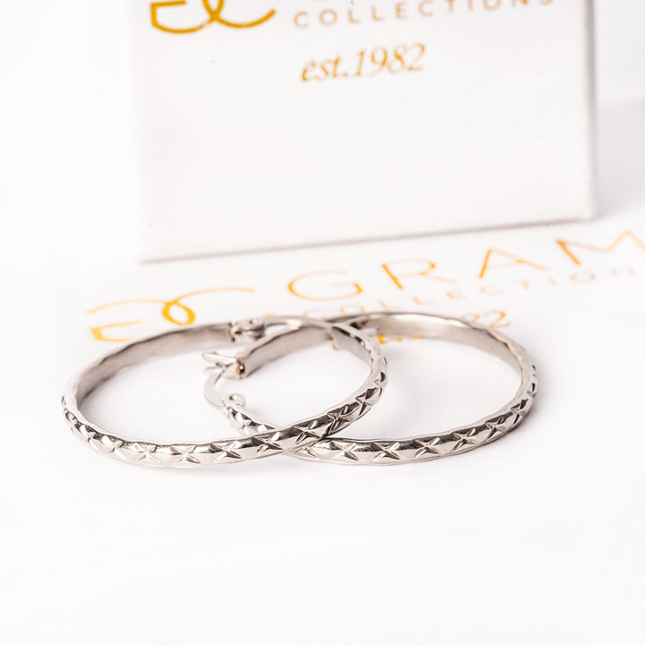 a close up view of Simone earrings standing in the center of the image against a white background. 