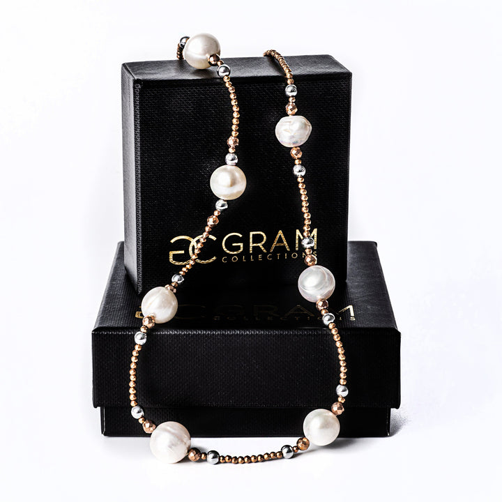 A sky necklace placed on its box standing in the center of the image. 