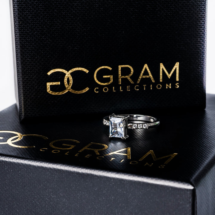 Sonia Silver Ring standing in the center of the image placed on its box. 