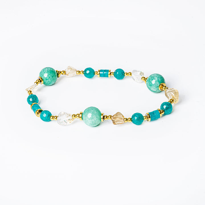 A close up view of spring bracelet placed in the center of the image against a white background. 
