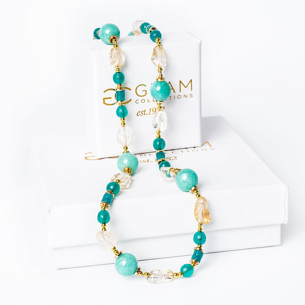 Spring Necklace placed on its box against a white background. 