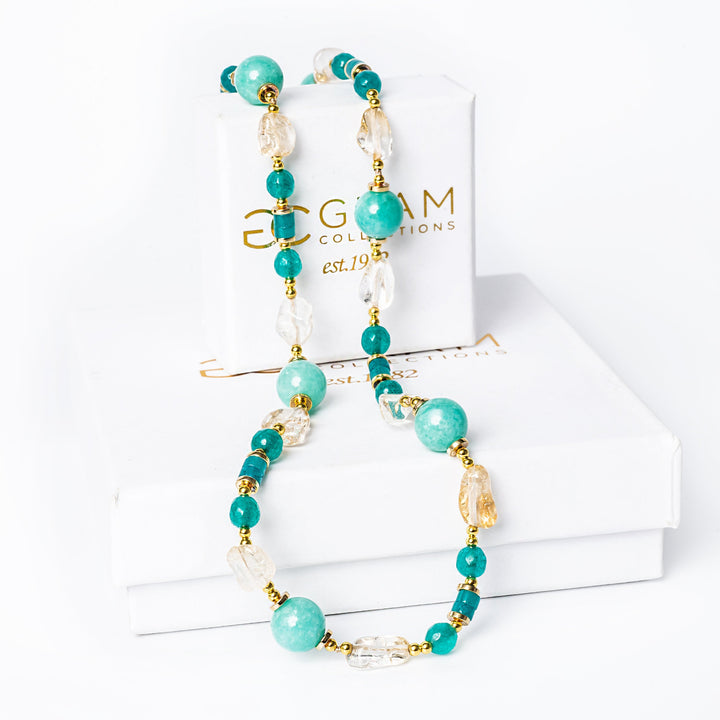 Spring Necklace placed on its box against a white background. 