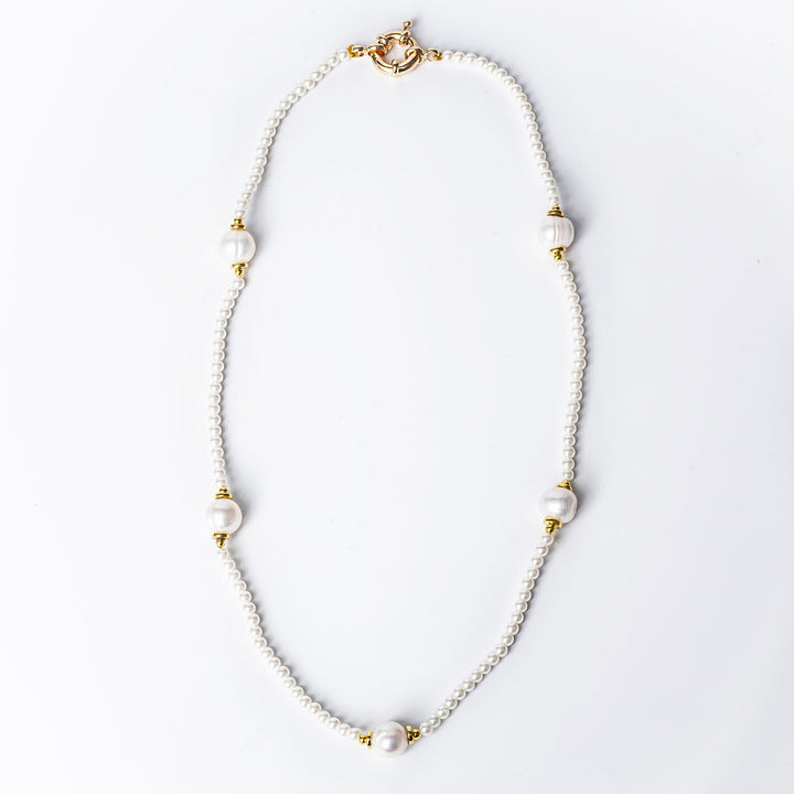 A close up view of Star Necklace standing in the center of the image against a white background 