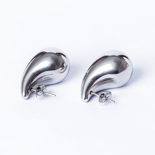 A pair of silver hoop Stella earrings with a gold plated finish on a white background.