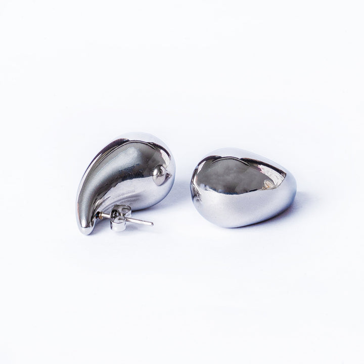 Stella Silver Earrings standing in the center of the image against a white background. 