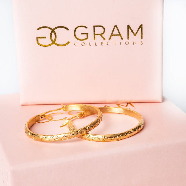 Sue earrings placed on top of each other on their uniquely designed Gram collections box. 