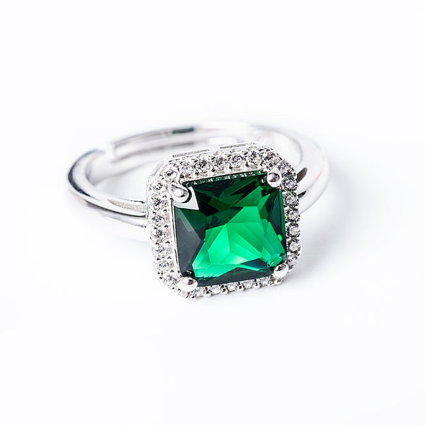 A sterling silver Susan Ring with a green cubic zirconia center stone surrounded by smaller clear cubic zirconia accents.