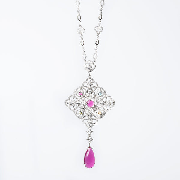 Tamara necklace with a geometric-patterned pendant featuring multicolored gemstones and a single pearl-like bead.