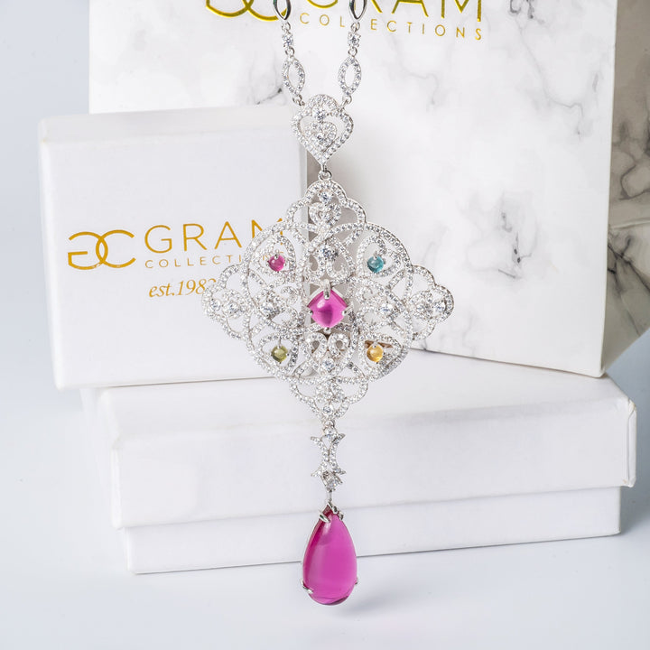 Tamara Necklace standing in the center of the image against its white box. 