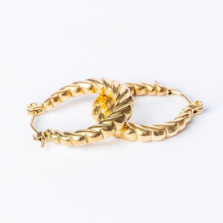 Tania Gold Earrings on top of each other. 