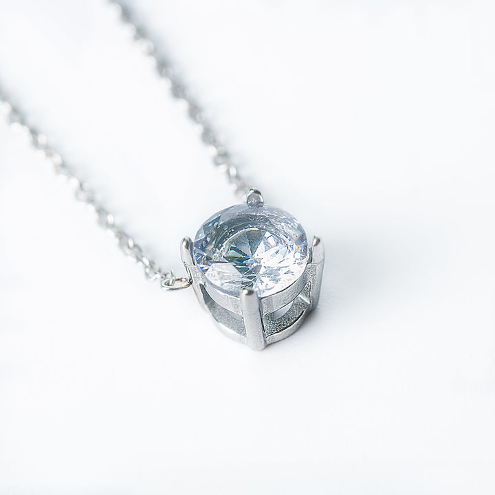 Silver Tessa necklace featuring a single round clear gemstone pendant.