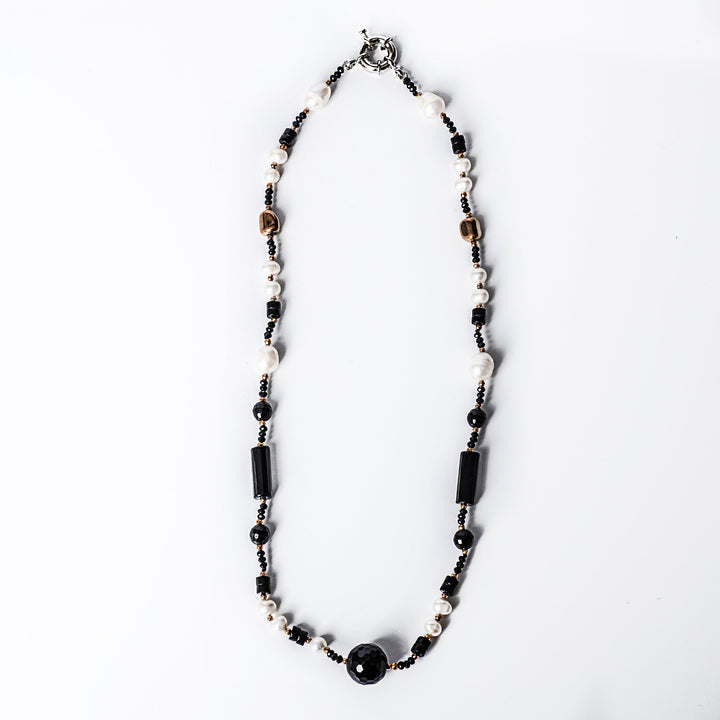A birdview of MoonLight Necklace  standing in the center of the image agains t a white background. 
