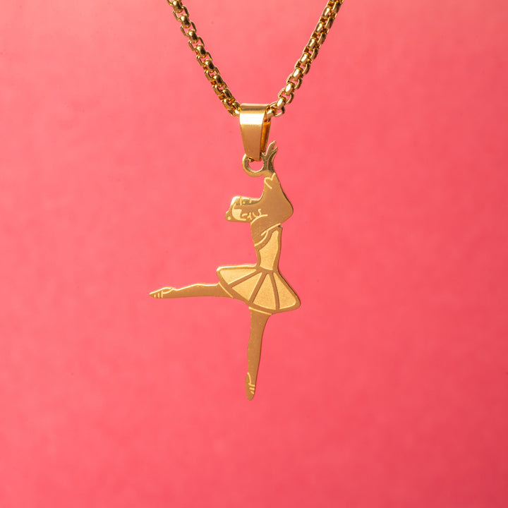 A close up view of The Ballerina Necklace standing in the center of the image against a red background. 