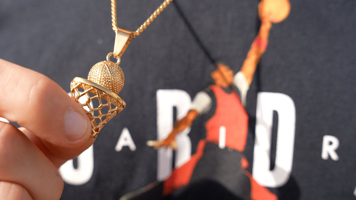 The Basketball Player Necklace standing in the center of the image 