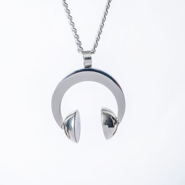 A gold-plated stainless steel DJ necklace with a pendant in the shape of a pair of headphones. The necklace has a chain and is displayed against a white background.