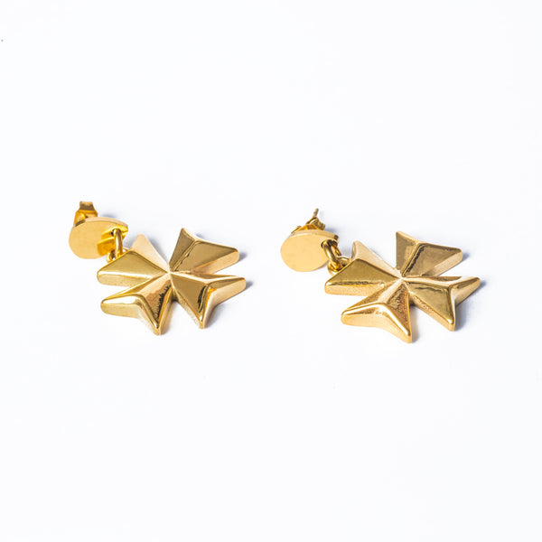 A pair of gold-colored, eight-pointed cross earrings on a white background