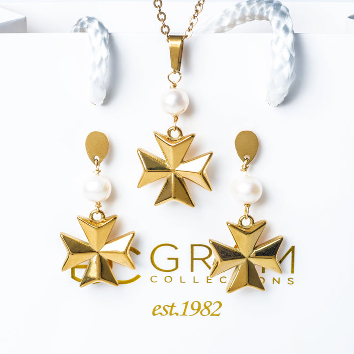 The Eight Pointed Pearl Cross Earrings placed on its box with Gram collections logo on it. 