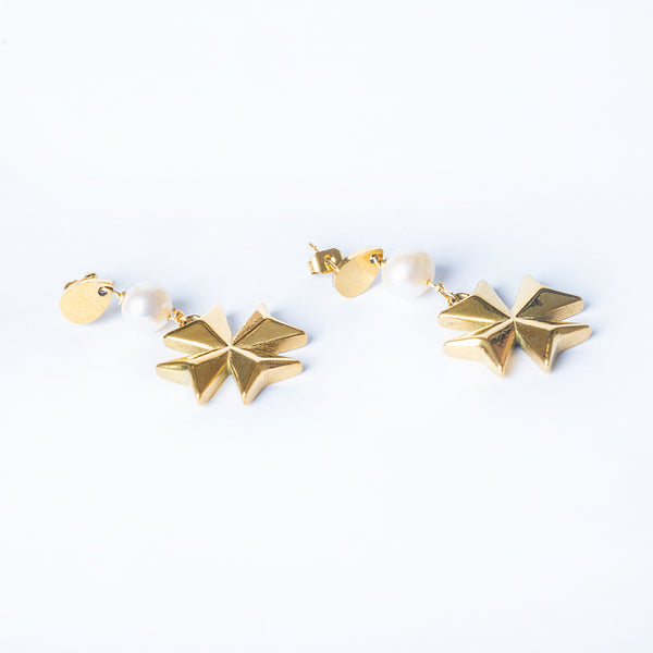 A pair of gold-plated stainless steel Eight pointed pearl earrings with cultured white pearl embellishments, designed in an eight-pointed star shape, displayed against a white background.