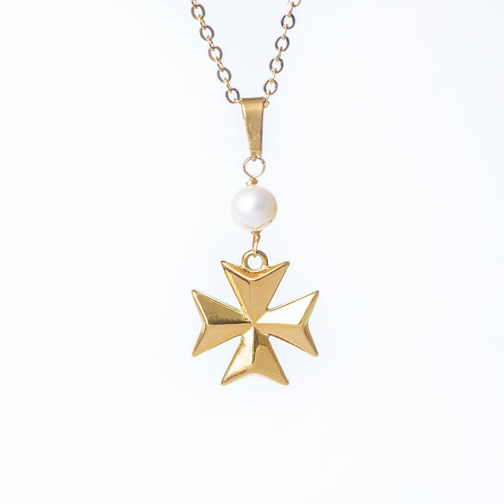 A close up view of Eight pointer pearl cross necklace standing in the center of the image against a white background. 