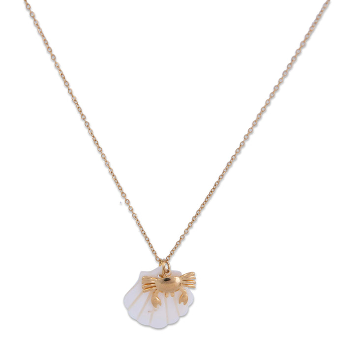 The gram collection anchor bay necklace with a shell pendant featuring at gold fish on a white background