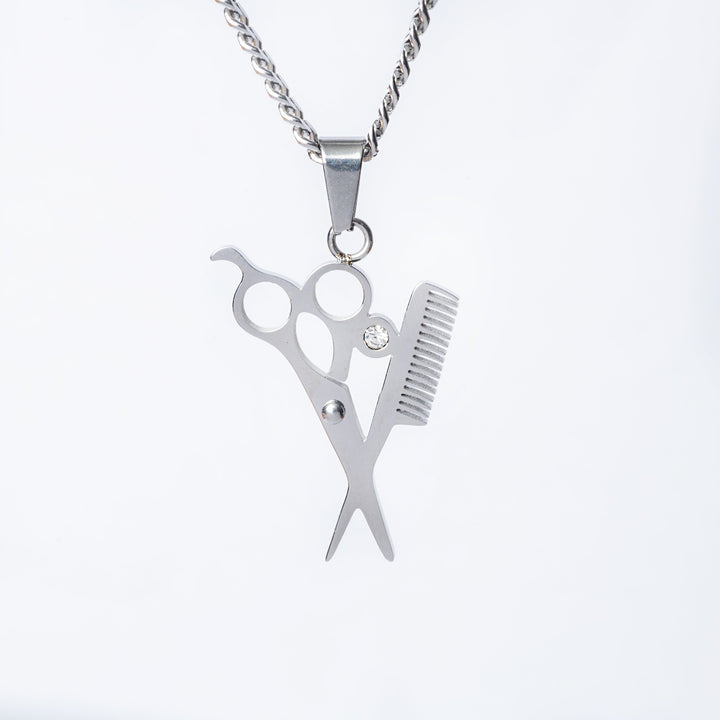 A close up view of The Hairdresser Necklace standing in the center of the image against a white background. 