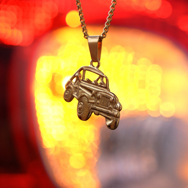 The Off Road Necklace standing in front of orange-red- bluer light background. 