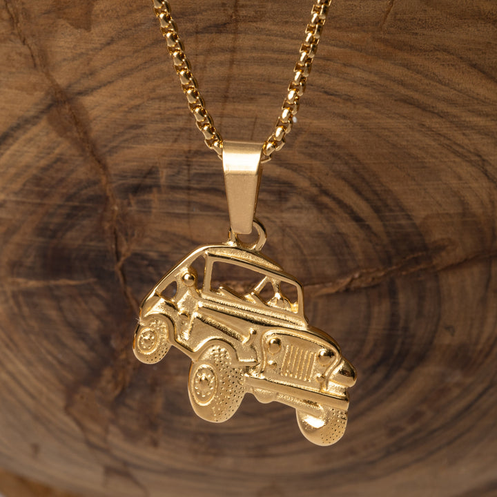 The off road necklace standing in the center of the image against a wooden background.