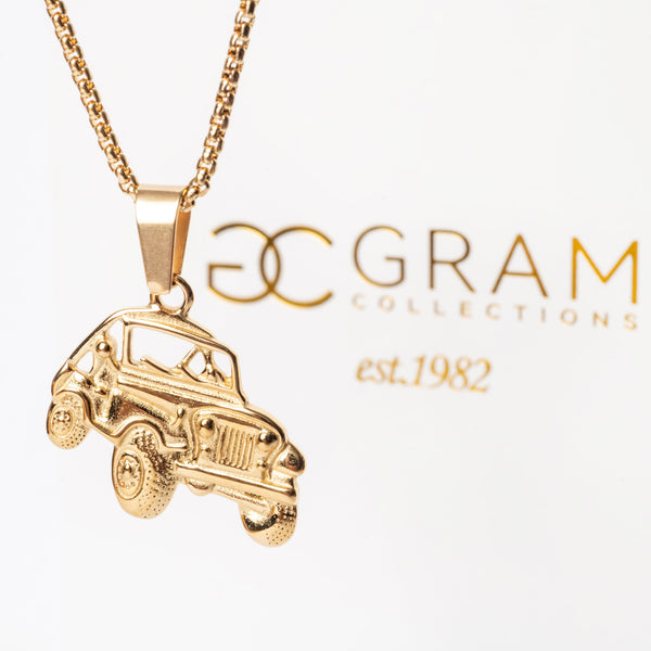 A gold-colored stainless steel  Off Road Necklace with a pendant in the shape of a car. The chain is displayed in the background with the brand 'G Gram Collections' featured.