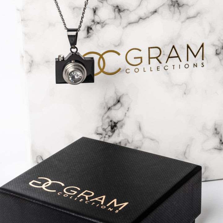 The photographer necklace standing in the center in the left-side of the image, surrounded by its white and black gram collections boxes. 