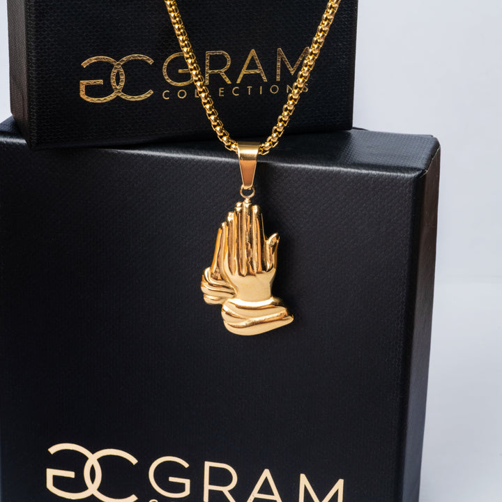 The religious necklace placed in the center of the image with its boxes. 
