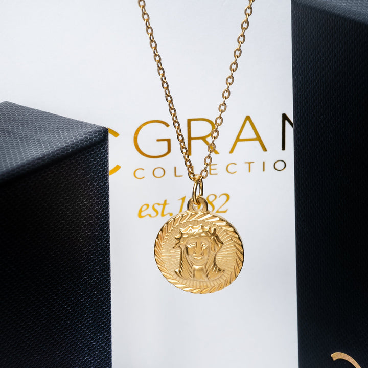 The saviour necklace placed on the side of the box near its black box. 