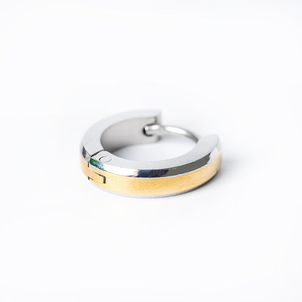 A pair of silver and yellow gold hoop Thomas earrings on a white background
