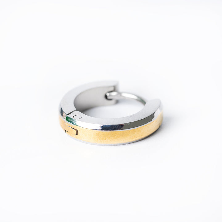 A pair of silver and yellow gold hoop Thomas earrings on a white background