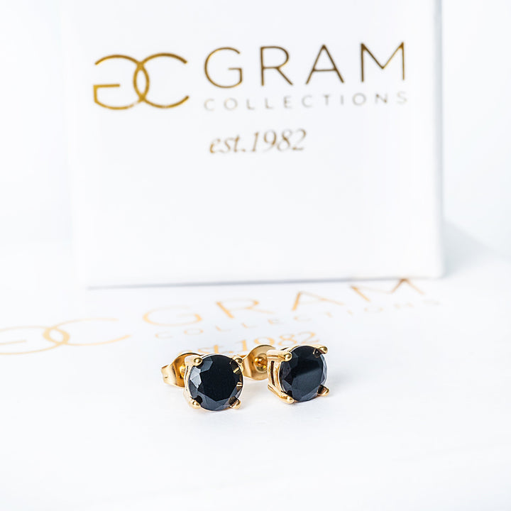 A Tommy Black Earrings standing against a white background. 