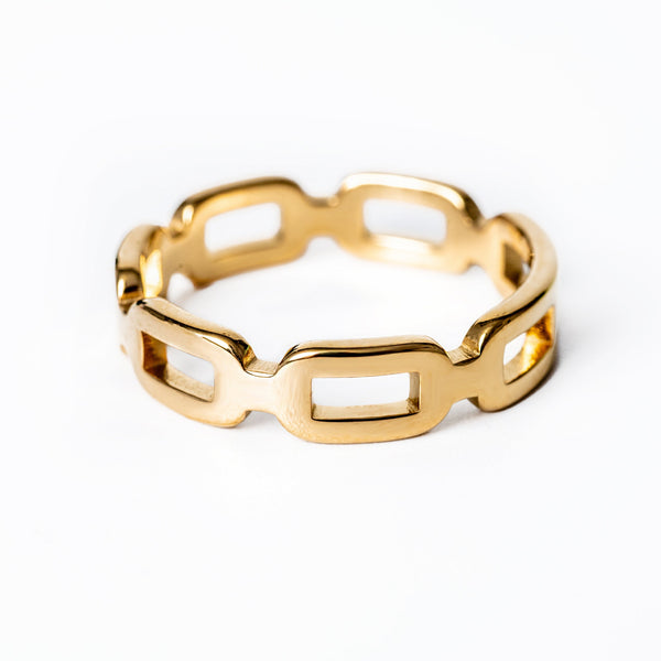 A gold-plated stainless steel ring with a yellow gold finish, featuring a textured design, displayed on a white background.